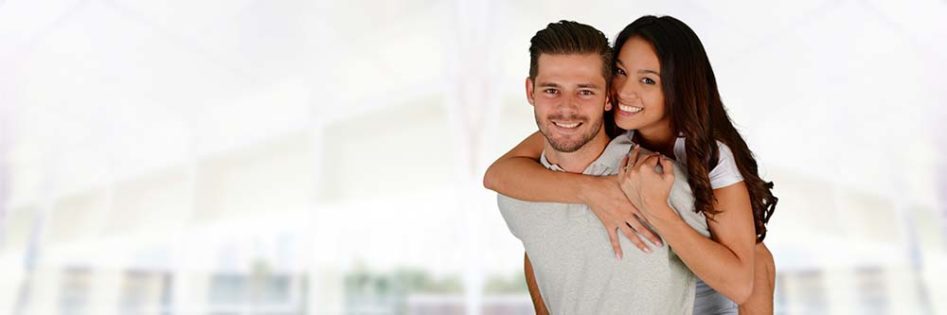 Man and woman posing together inside their home